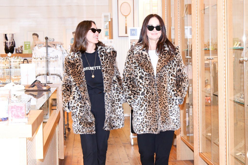 Katrina and Caroline photographed wearing matching leopard print coats at the Hills of Kerrisdale store in Vancouver, BC.